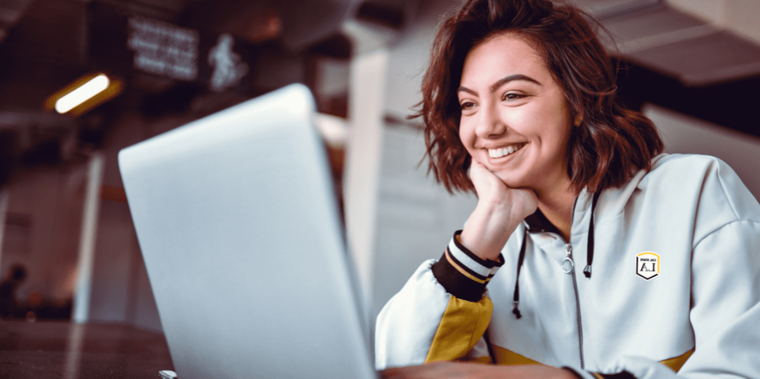 Female student takes online class via her laptop.